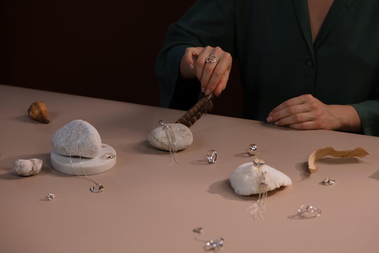Elegant jewelry arrangement with rocks and natural textures on a table.